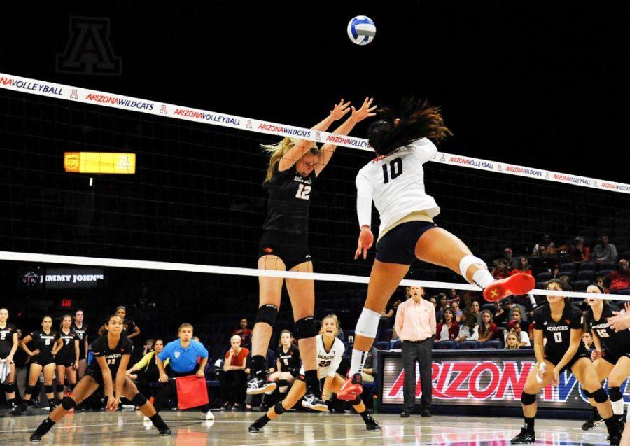 Arizona outside hitter Kalei Mau (10) spikes the ball on Oregon State outside hitter Katelyn Driscoll (12) Sept. 30. The Wildcats will look to avenge an earlier loss to Oregon as they take on the Ducks in Eugene on Friday.