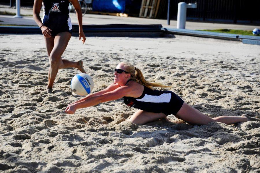 Arizona beach volleyball athlete Sam Manley dives to dig the ball during a practice on Thursday, Oct. 6. 