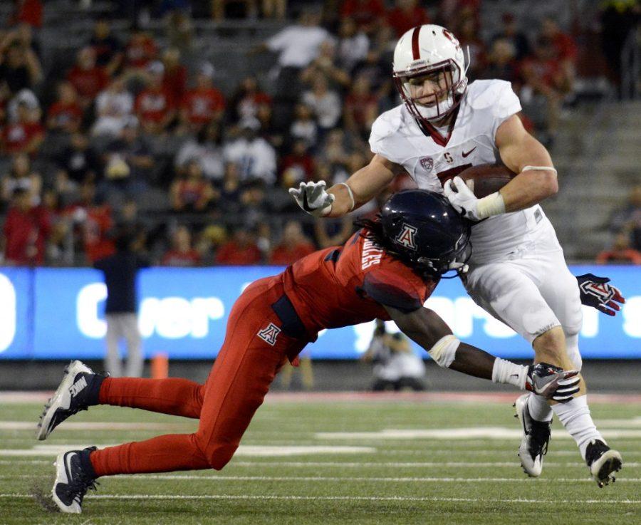 Arizona+defender+Demetrius+Flannigan-Fowles+%286%29+launches+himself+against+Stanford+running+back+Christian+McCaffrey+%285%29+at+Arizona+Stadium+on+Saturday%2C+Oct.+29.+The+Wildcats+lost+to+the+Cardinal+34-10.