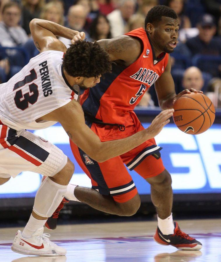 Arizona Wildcats guard Kadeem Allen (5) drives as Gonzaga Bulldogs guard Josh Perkins (13) chases to defend during the first half of the No. 19 Arizona Wildcats vs. No. 13 Gonzaga Bulldogs mens NCAA college basketball game at McCarthey Athletic Center in Spokane, Wash. Arizona used a second-half comeback to win 68-63.

