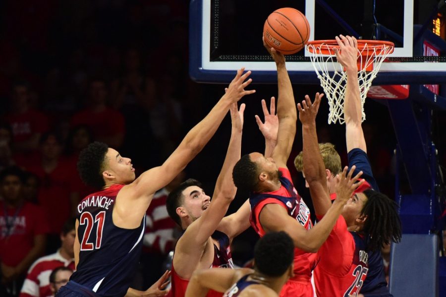 Arizona guard Parker Jackson-Cartwright tips in a basket amid heavy defense during the Red and Blue scrimmage in McKale Center on Oct. 14. UA participants in a set of basketball tests scored more points after being prompted about death than those who were not given the prompt.