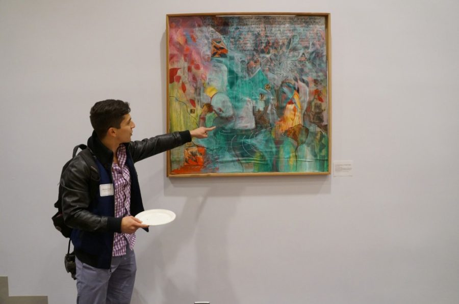 Neuroscience and cognitive science graduate Michael de Leon looks at artwork at 2015 Symbiosis: An Exhibit of Biological Art event. This years event features over 70 pieces of art from community members. 