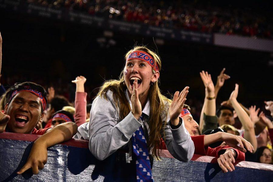 Students in the ZonaZoo section celebrate a touchdown during Arizonas 56-35 win against ASU in Arizona Stadium on Friday, Nov. 25, 2016. 