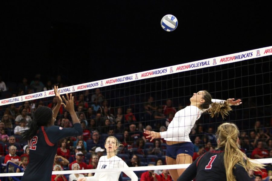 Arizona outside hitter Katarina Pilepic spikes a ball at Stanford middle blocker Inky Ajanaku during Sundays game in McKale Center. No. 12 Stanford swept the Wildcats 3-0.