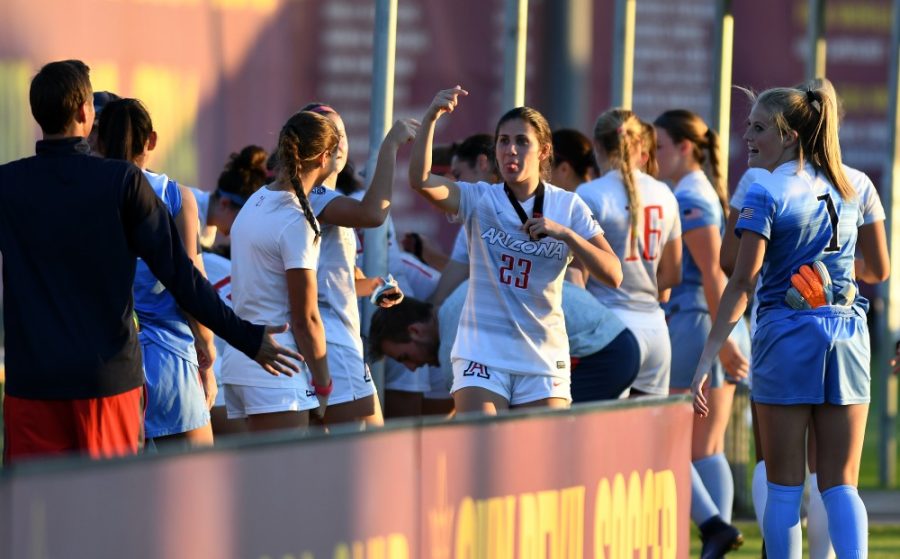 Arizona goalkeeper Lainey Burdett (1) and teammates laugh as Arizona defender Samantha Falasco (23) makes a face at assistant coach Paul Nagy (left) after their win over ASU at Sun Devil Soccer Stadium in Tempe on Friday, Nov. 4, 2016. The Wildcats shut out the Sun Devils 1-0 for their first Territorial Cup win in soccer since 2013.