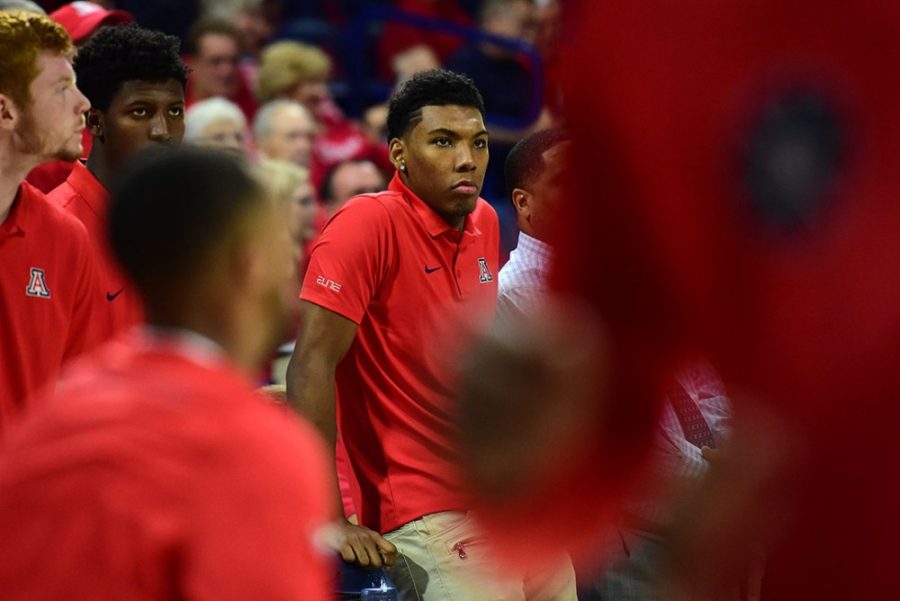 A stone-faced Arizona guard Allonzo Trier watches from the sidelines as his teammates warm up for Arizonas exhibition match-up against the College of Idaho at McKale Center on Tuesday, Nov. 1, 2016. 