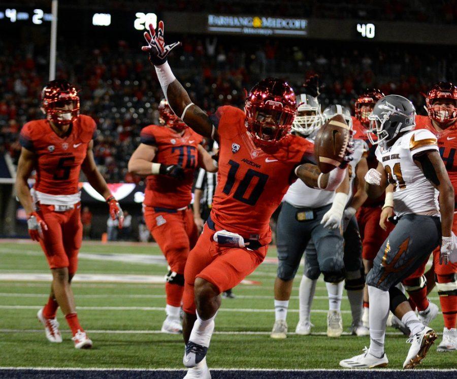 Arizona running back Samajie Grant (10) celebrates after scoring another touchdown during the 2016 Territorial Cup at Arizona Stadium on Friday, Nov. 25. The Wildcats took home the Territorial Cup after triumphing over the Sun Devils 56-35.