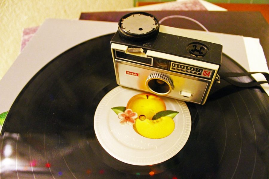 A retro Kodak Instamatic 154 camera sits on a vinyl record on Monday, Jan. 9. Older camera styles have been gaining popularity in recent years.