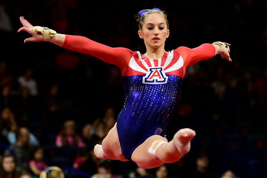 Madison Cindric does a midair split while warming up for her floor routine during Arizonas 194.025-191.600 win over Utah State and Texas Womans at McKale Center on Friday, Jan. 6, 2017. 