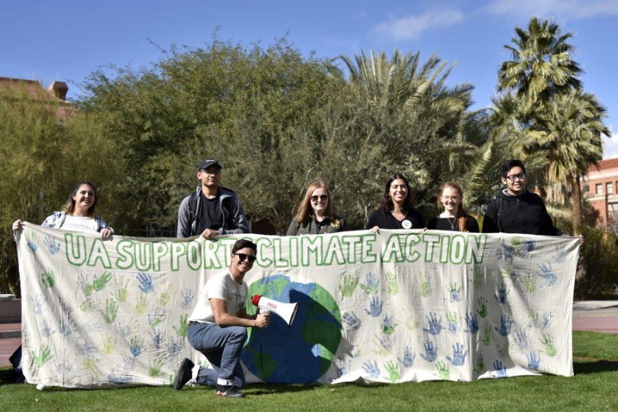Students hold up a banner for the Climate Change & Action walkout on Jan. 23.  The event was led by members of UAs Students for Sustainability organization.