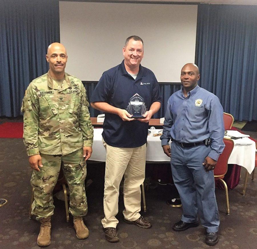Col. Jason Halloren (left), the 5th Brigade commander, and Command Sgt. Major of the 5th Brigade ROTC units, Roderick Hodo (right) present Lt. Col. Dale Barnett (center) of the Wildcat Cadre with the Cochise Award at Joint Base Sam Houston in San Antonio.