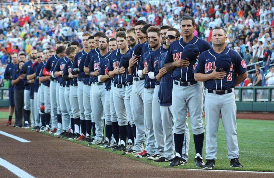 The Arizona baseball team stands on the first base line for the national anthem during their June 18, 2016, matchup against Miami in the 2016 College World Series. Arizona won the game 5-1.