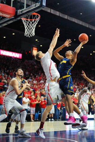 Lauri Markkanen (10) blocks a shot by Ivan Rabb (1) during the Men's Basketball game against California in McKale Center on Feb. 11.