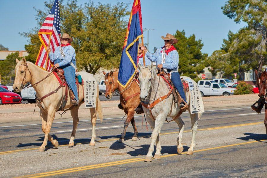 Individuals+representing+Benson+Pony+Express+present+the+American+flag+and+Arizona+flag+on+horseback+during+the+Tucson+Rodeo+Parade+on+Thursday%2C+Feb.+23.