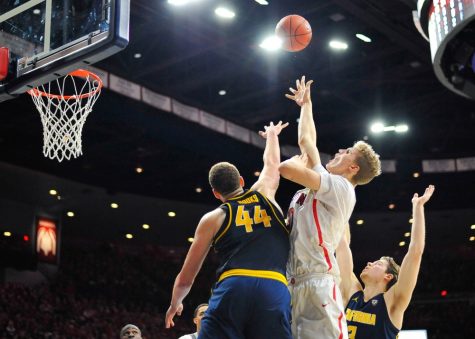 Arizona's Lauri Markkanen (10) shoots the ball while California's Kameron Rooks (44) attempts to block him during the Men's Basketball game in McKale Center on Feb. 11.