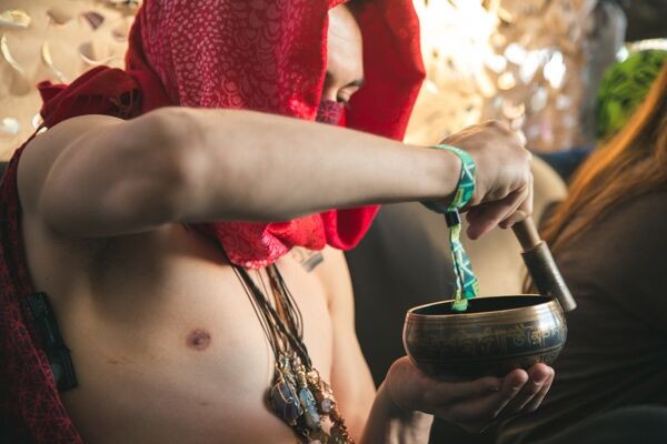 A festival attendee uses a Tibetan singing bowl during a past Gem and Jam. This years festival has moved to a new location, the Pima County Fairgrounds. `