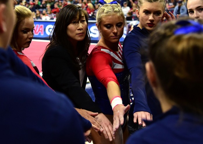 Head coach Tabitha Yim huddles with her team during Arizonas 194.025-191.600 win over Utah State and Texas Womans University in McKale Center on Jan. 6.