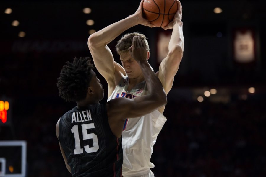 UAs+Lauri+Markkanen+gets+swatted+at+by+Stanfords+Marcus+Allen+%2815%29+during+the+UA-Stanford+game+on+Feb.+8.+UA+won+against+Stanford+74-67.