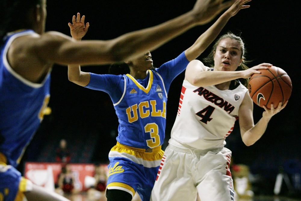 Arizona guard Lucia Alonso (4) protects the ball from UCLA guard Jordin Canada (3) during the women's basketball game on Feb. 24 in McKale Center.