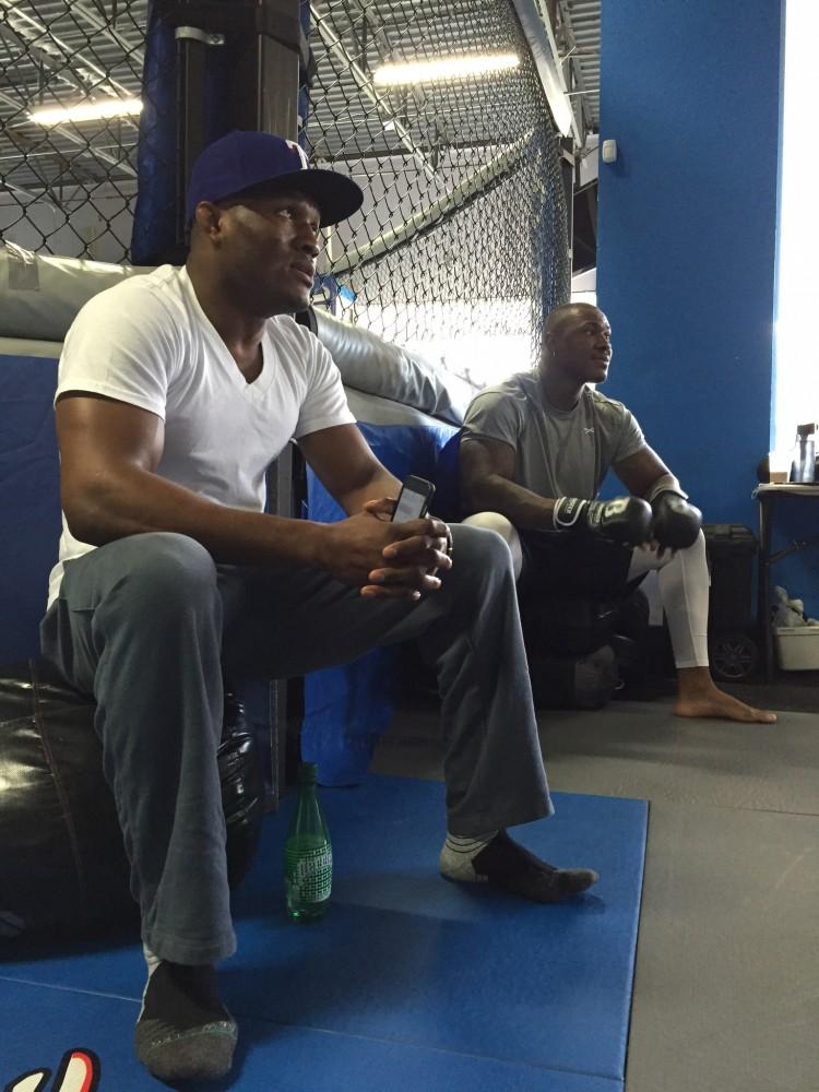 Kamaru Usman (left) and his brother, Mohammed (right), sit around the MMA Octagon. Mohammed is trying to follow his brother's footsteps and fight in the UFC.