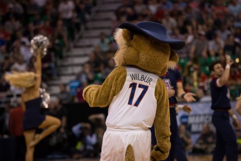 Wilbur Wildcat gets groovy while the Arizona band plays, during halftime at the UA-SMC game on Thursday, March 18.