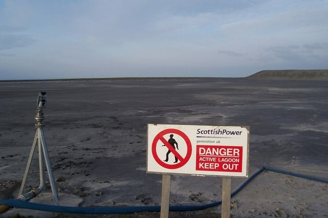 The water hose to the left of the shot is to dampen the ash to prevent it from blowing across the area. The lagoon is used to hold fly ash produced by the burning of coal at Cockenzie Power Station.
