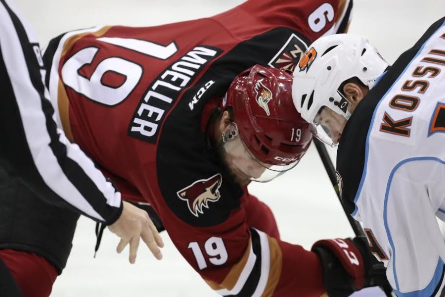 Tucson Roadrunners alternate captain Chris Mueller taking a faceoff against San Diego Gulls center Kalle Kossila on Friday, March 3rd in San Diego, Calif. 