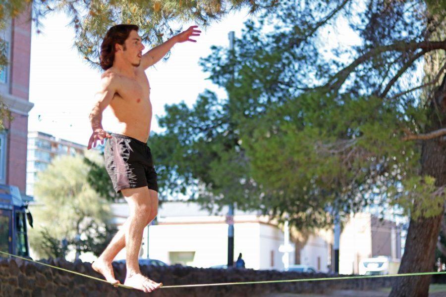 Harry Kleiman slacklines on campus on Saturday, March 11. Slacklining originated from the climbing community as a way to train balance and mental strength.