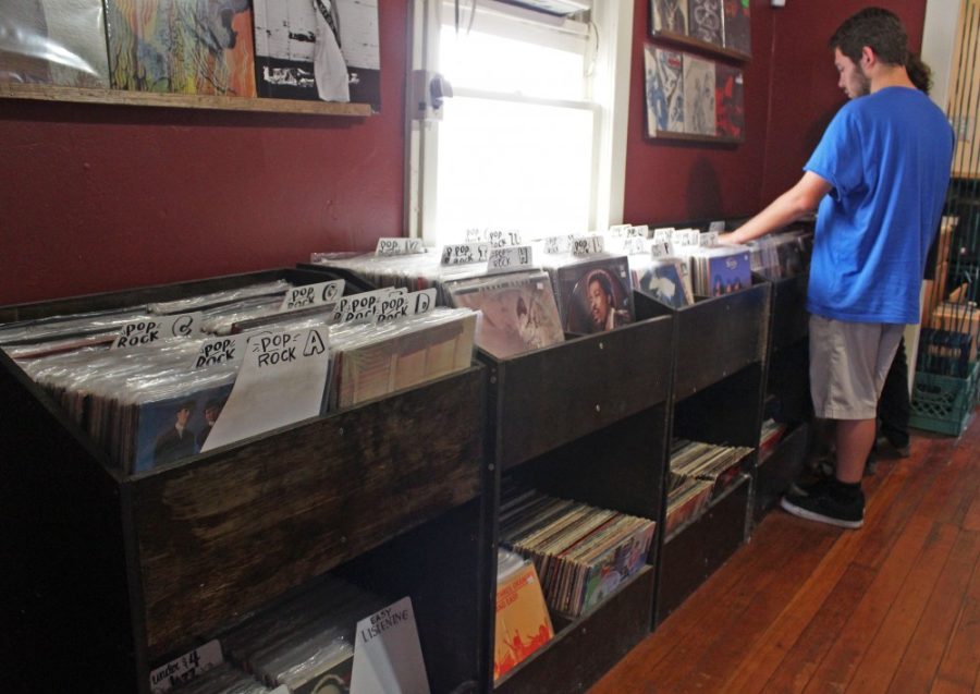 Customers browse the vinyls at Wooden Tooth Records on Seventh Street on April 22. Though vinyl was replaced for more modern technologies, many people in Tucson still collect records.