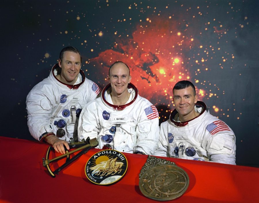 The original Apollo 13 prime crew. From left to right are: Commander, James A. Lovell, Command Module pilot, Thomas K. Mattingly and Lunar Module pilot, Fred W. Haise. On the table in front of them are from left to right, a model of a sextant, the Apollo 13 insignia, and a model of an astrolabe. The sextant and astrolabe are two ancient forms of navigation.Command Module pilot Thomas Ken Mattingly was exposed to German measles prior to his mission and was replaced by his backup, Command Module pilot, John L.Jack Swigert Jr.