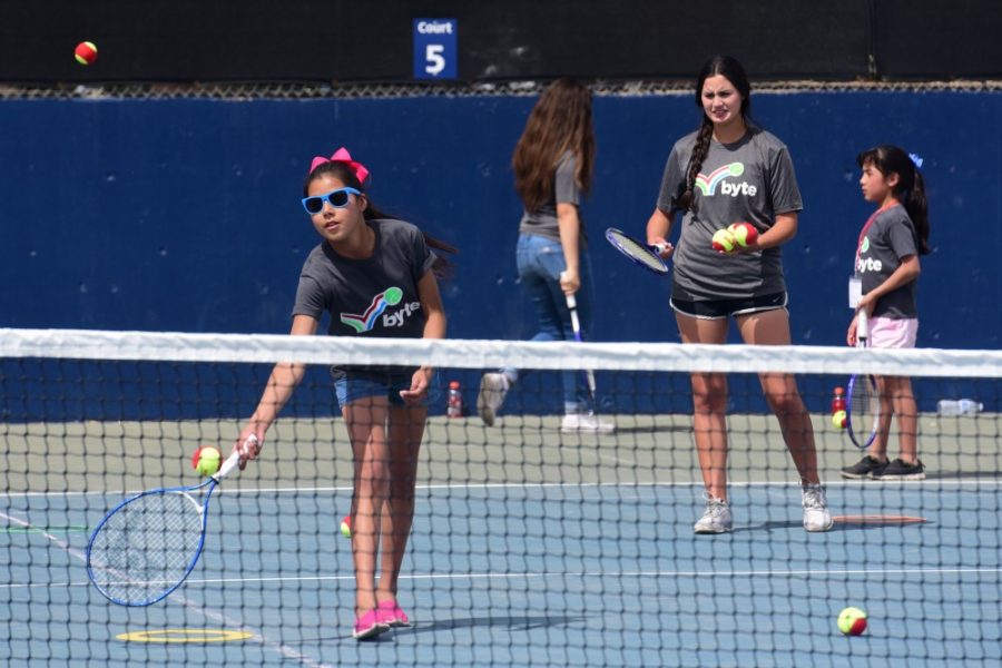 A participant in the Border Youth Tennis Exchange (BYTE) reaches for a low forehand at the Robson Tennis Center on Sunday, April 9, 2017. The Arizona mens tennis team hosted a tennis clinic for BYTE, a youth program that engages children ages 8-12 from both Nogales, Ariz. and Nogales, Sonora through tennis, after their Sunday morning match against Oregon.