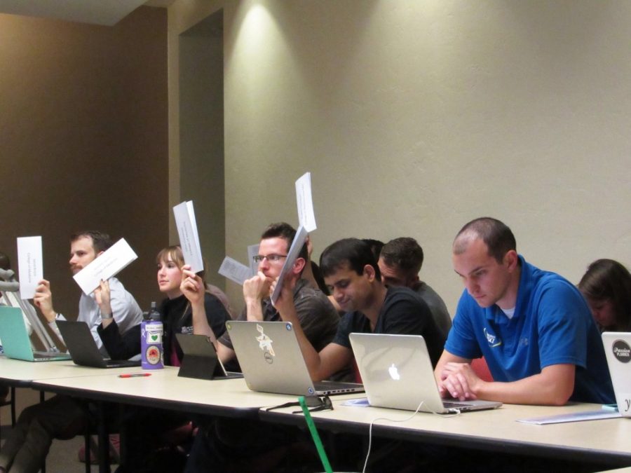 Graduate and Professional Student Council members vote during a meeting on April 3 in the pima room at the student union. The council reviewed next years budget and the elections.