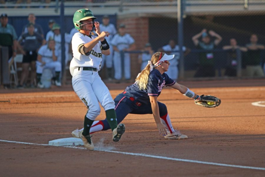 Arizona infielder Jessie Harper catches the ball as a Baylor player crosses the base during the softball game against Baylor on May 27 at Hillenbrand Stadium.