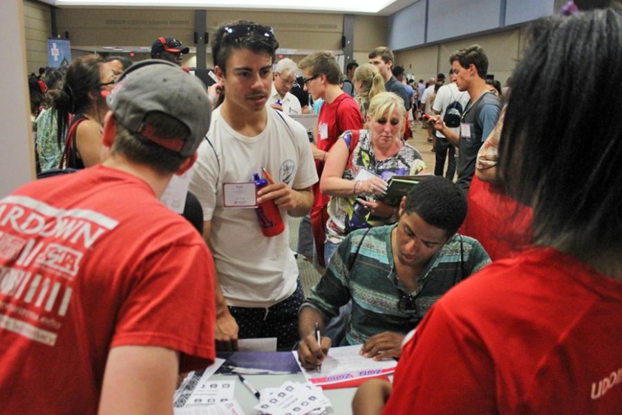 Jacob Borcover, left, and Inyene Udoinwang, right, answer questions from incoming freshmen and parents during the UA Orientation Fair on June 9, 2014. The transition in lifestyle and responsibility from high school to college often proves challenging for incoming freshmen.