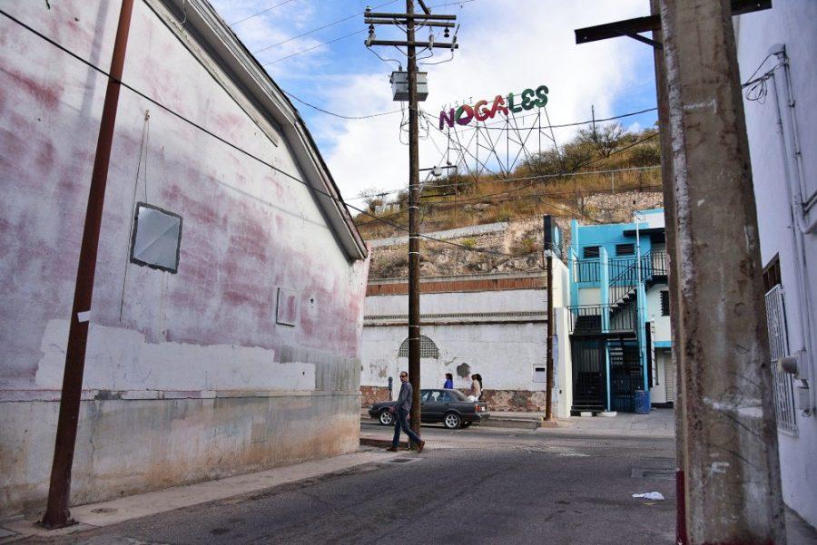 A sign reading Visit Nogales sits high up in the hills of Nogales, Sonora. David Pujol visited this city often during his childhood.