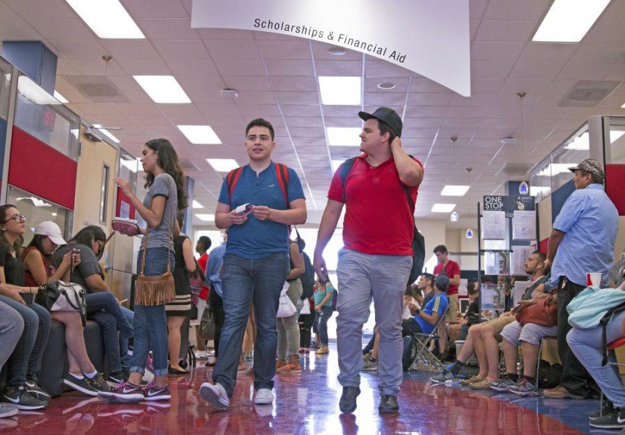 Students walk out of the office of scholarships and financial aid on the first day of classes, Aug. 21. At its peak, the wait time neared over two hours to be assisted.