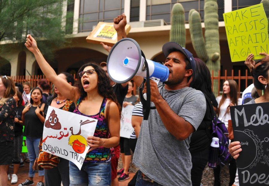 Goli Bagheri, left, and David Archuleta, right, shout the people, united, will never be divided at the Tucsonans Against Racism Protest and Rally in downtown Tucson on Aug. 22. DACA is an issue that has impacted young people in a big way. 