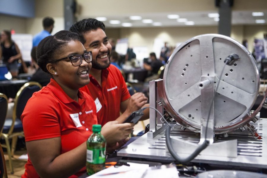 Members of the UA Hispanic Engineers Club enjoy a moment interfacing with technology. The UA will host a national congress on Hispanics in STEM in November.