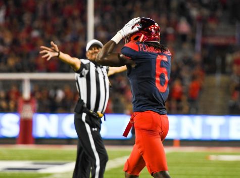 Arizona safety Demetrius Flannigan-Fowles walks across the field with his hands on his head during the UA-Houston game at Arizona Stadium on Sept. 9.