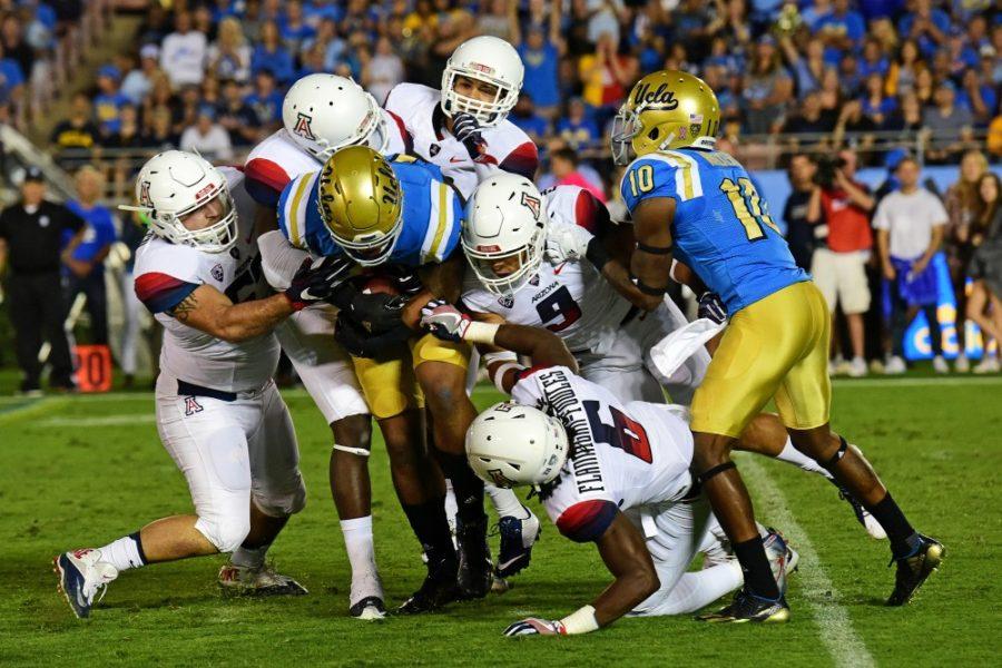 A ring of Arizona defense ends UCLA tight end Nate Ieses (11) run during Arizonas 45-24 loss to UCLA at the Rose Bowl Stadium in Pasadena, Calif. on Oct. 1, 2016.