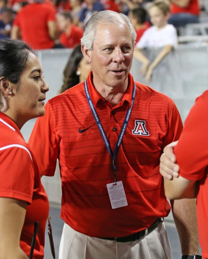 University of Arizona President Robert Robbins talks among Arizona Athletics staff during the UA-NAU football season opener on Sept. 2.