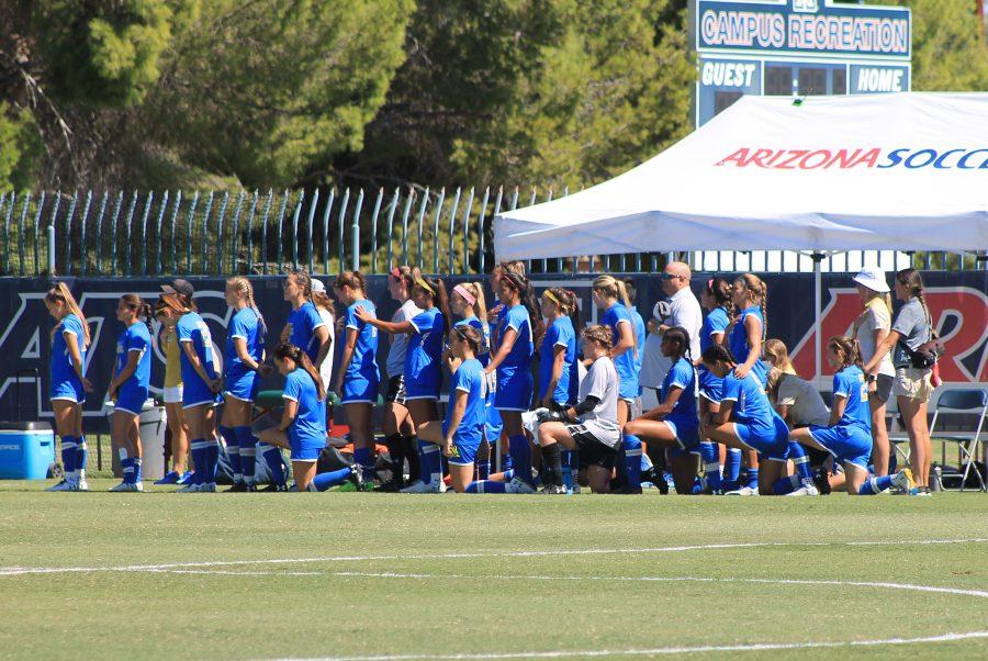 The UCLA womens soccer team kneels during the National Anthem at Murphy Field on Oct. 8. 