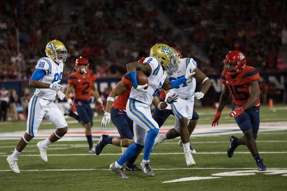 UCLA's Jordon Lasley (2) tries to get past Arizona defense during the UA-UCLA game on Saturday, October 14.