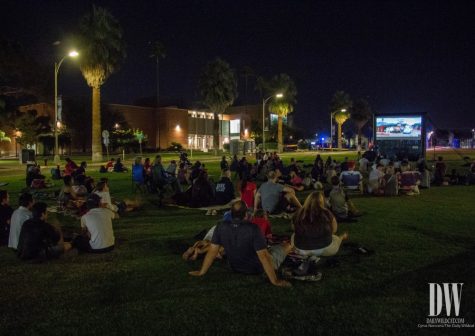 University of Arizona students and their families gather around the UA Mall to watch Cars 3 for Family Movie Night during Family Weekend on Oct. 13.