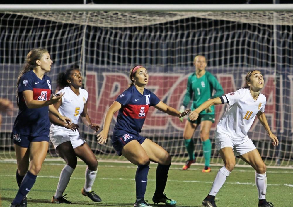 Arizona's Charlotte Brascia (10) looks up at the ball with USC players on Oct. 5. 
