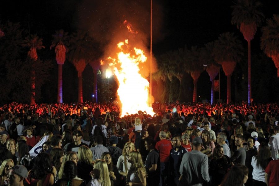 A crowd gathers around the Homecoming bonfire outside of Old Main on Nov. 7, 2014.