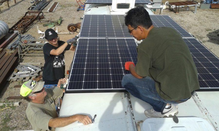 Members of the UA-AATech team mount solar panels on the roof of the desalination bus made for the Navajo Nation by the UA College of Engineering. According to STAR School CEO Dr. Mark Sorensen, the inspiration to use desalination techniques came from the Standing Rock protests of the Dakota Access Pipeline.