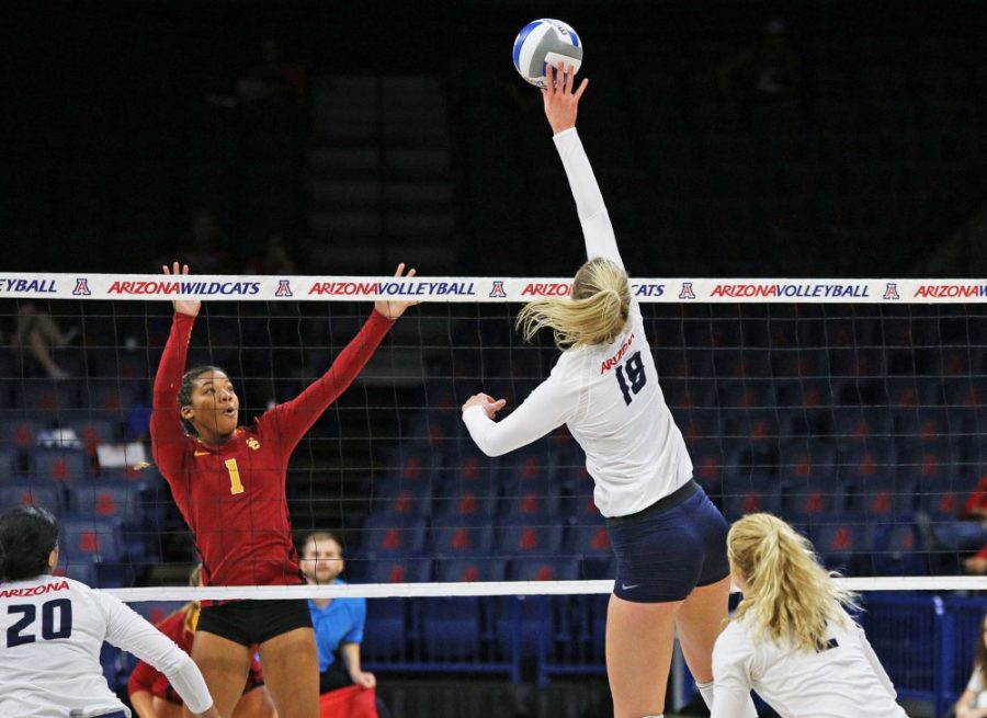 Arizona middle blocker Mckenzie Jacobson (18) tips the ball over the net during Arizonas 3-2 win against USC on Nov. 2, 2016 in McKale Center.