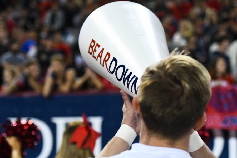 An Arizona cheerleader yells out of a Bear Down cone during the UA-Oregon State game on Nov. 11 at Arizona Stadium.