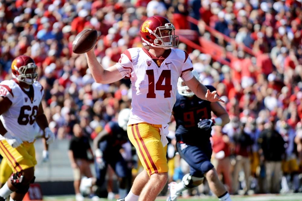 Sam Darnold rolls out to the right and gets set to throw a pass against Arizona in 2016.